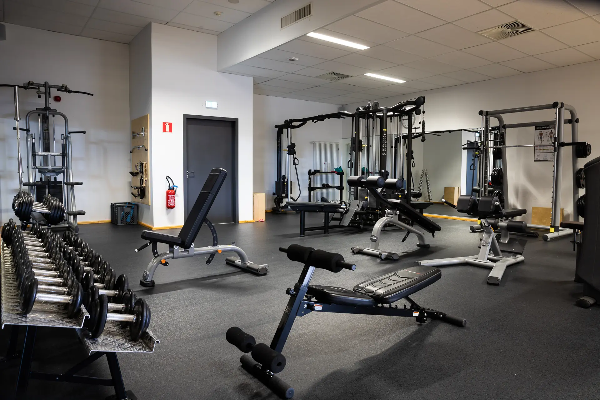 Fitnessraum bei AquaNat'Our für Mitglieder mit modernen Geräten und Hanteln.